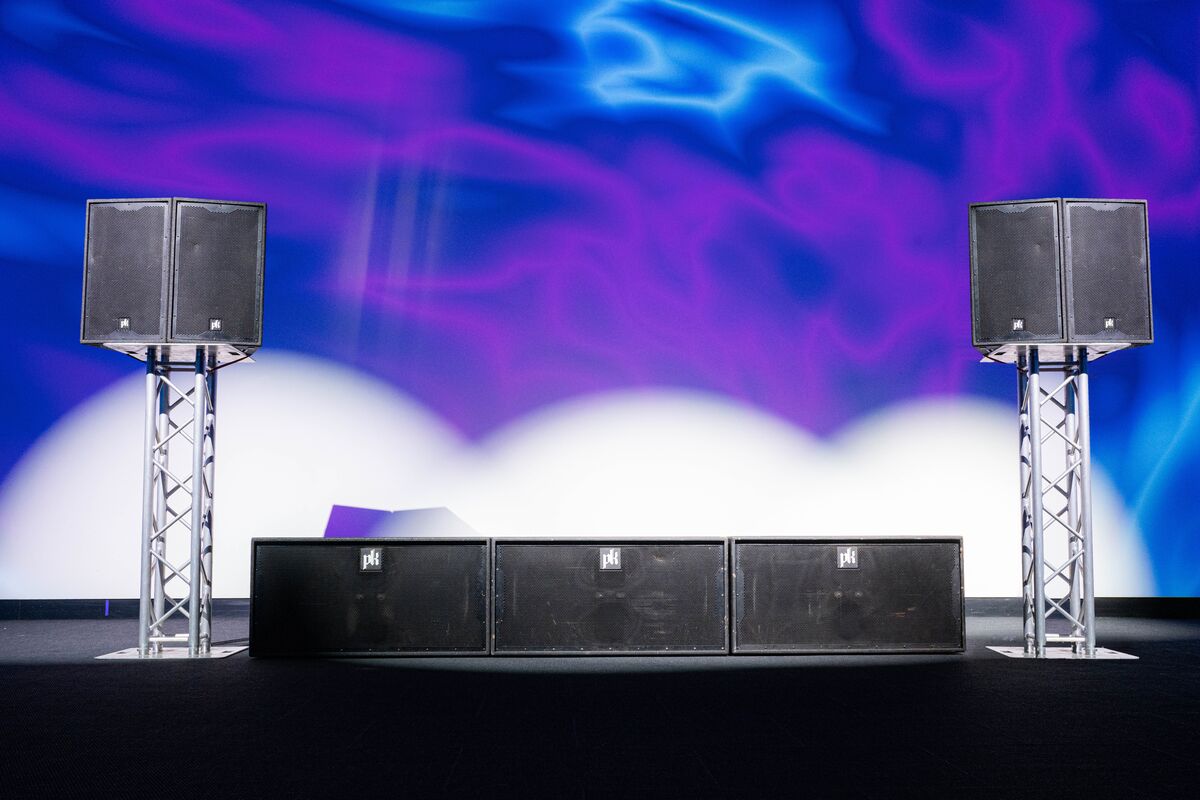 Three CX800 subwoofers in a row between pairs of CX215 tops on truss totems.